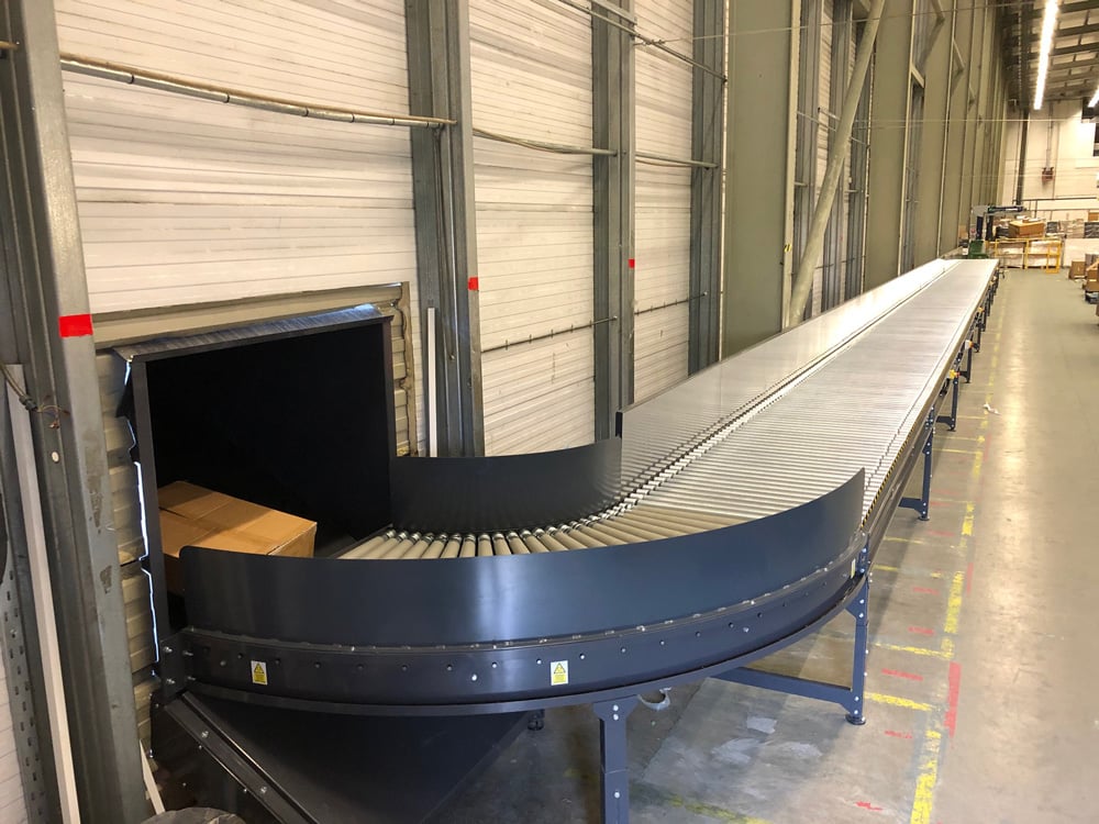 Conveyors transporting cardboard to channel press